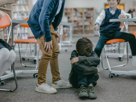 Sad Boy in Gray Sweater Sitting on the Floor