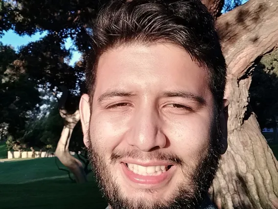 Abraham Venegas, smiling Latino person with short dark hair and beard