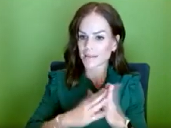 Image of Amber Hansen, a white woman with brown hair wearing a green blouse