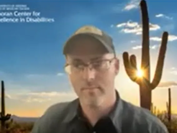 Screenshot of Austin Duncan, a white man in a collared shirt wearing glasses and a baseball cap.