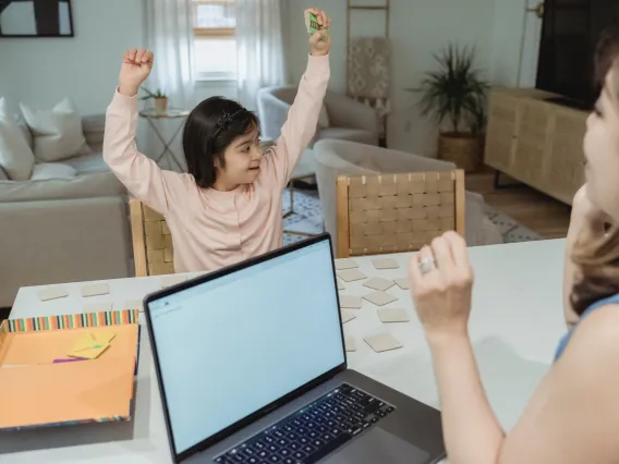 Mother is teaching Daughter at Table