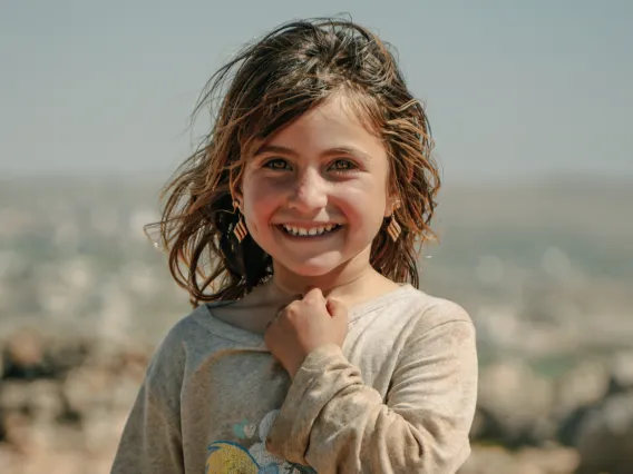 Smiling Kid with Hand on Neck