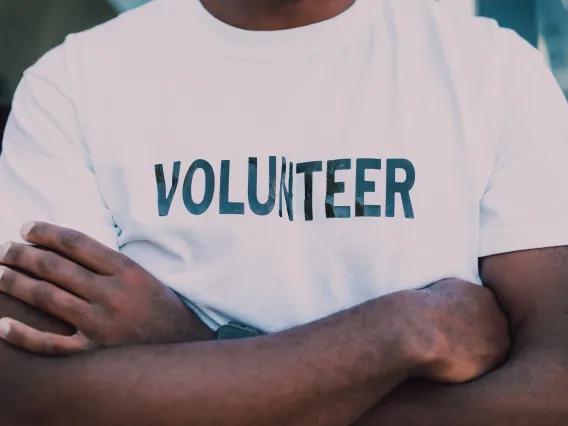 Crossed-arms man in a volunteer Tshirt