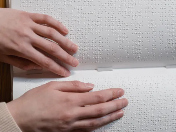 Close-Up Shot of a Person Touching a Braille