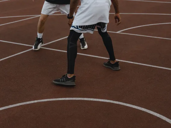 Two people playing basketball.