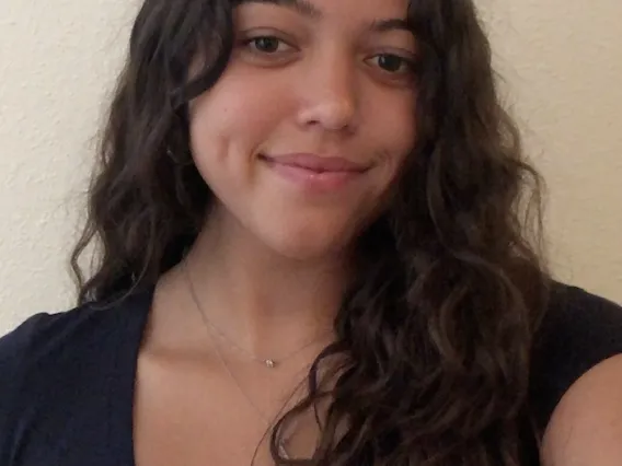 Isabella, smiling woman with medium length brown hair