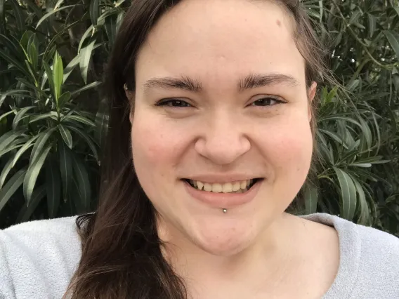 Jordan, smiling woman with long hair over her shoulder