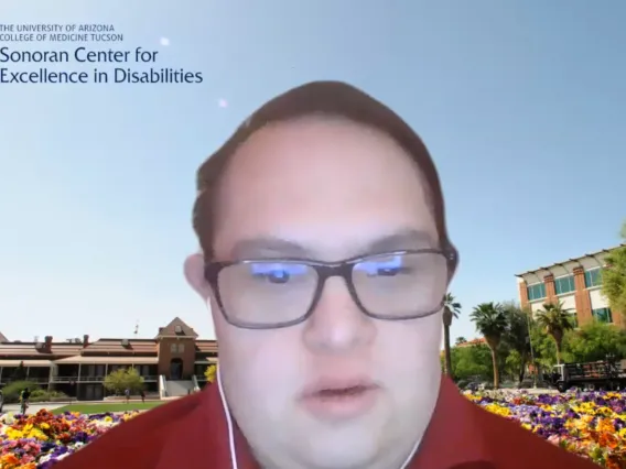 Man with glasses and a red polo on Zoom