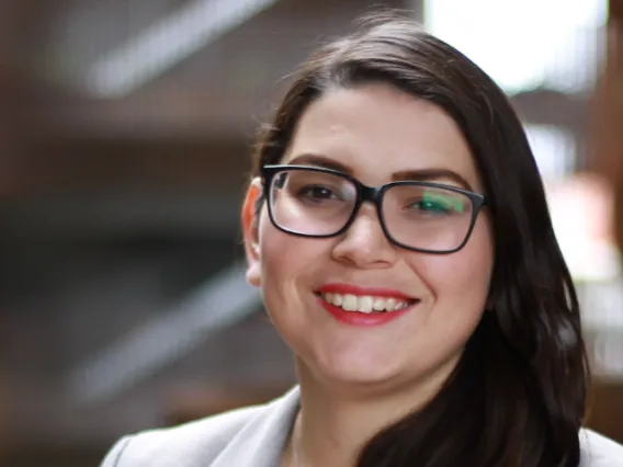 Roxanna, a girl with long dark hair and glasses smiling