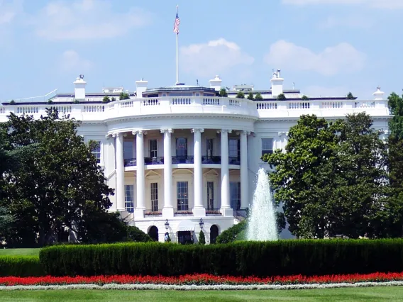 White Concrete Building With Flags on Top