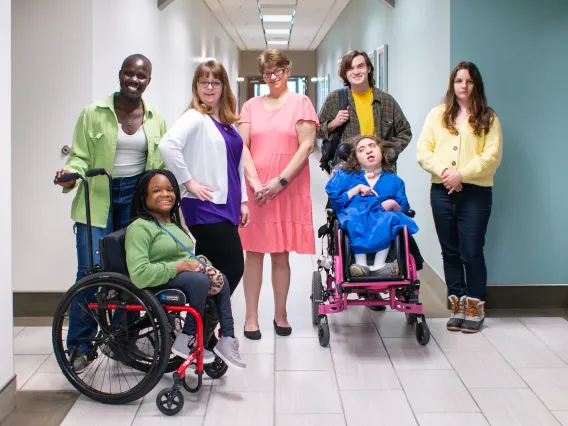 group of models selected for photo library pose in hallway