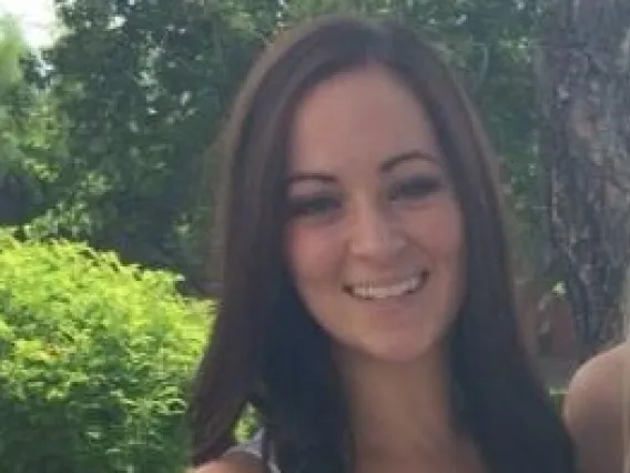 Woman with long hair in tank top smiling