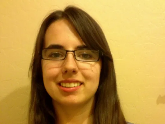 Woman in long hair with glasses smiling