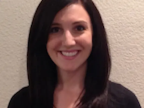 Woman with long dark hair smiling