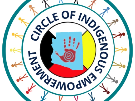 One large circle outlined in blue. Within is another circle with the stick figure people around the border. Within that circle  is the phrase "Circle of Indigenous Empowerment" flowing in the shape of the circle. Within that circle is the state of Arizona in blue with a red handprint in the center on top of a circle with white to the top, yellow to the right, red to the bottom and black to the left of the circle. 