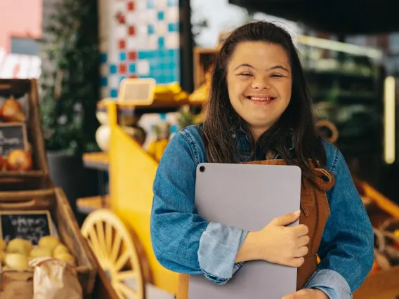 Woman with Down Syndrome working at a market.