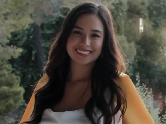 Headshot of Victoria Martinez, a young woman with long brown hair.