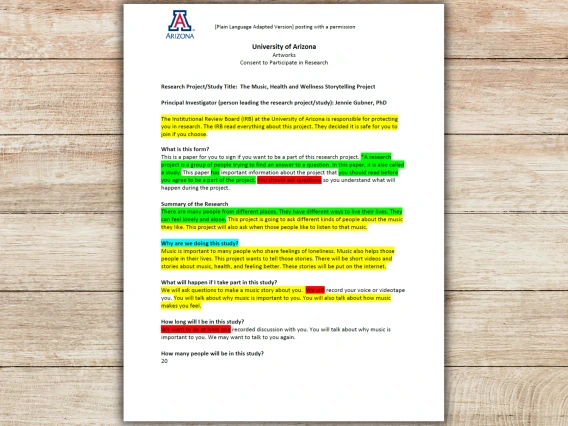 Cover of University of Arizona Artworks Consent to Participate in Research Document in Plain Language on a wooden background.