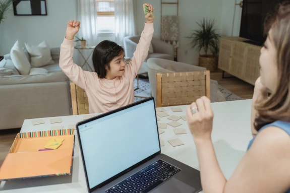 Mother is teaching Daughter at Table