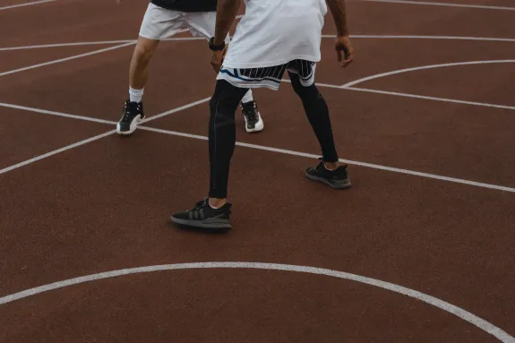 Two people playing basketball.
