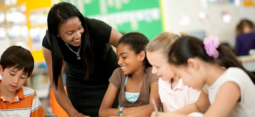 A Teacher is smiling and talking to her students
