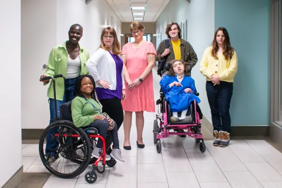 group of models selected for photo library pose in hallway