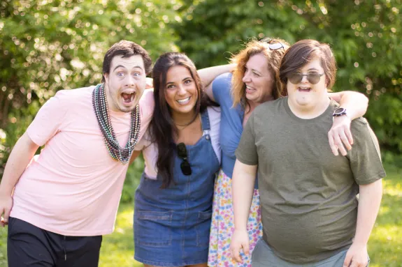 A group of 4 young people smiling