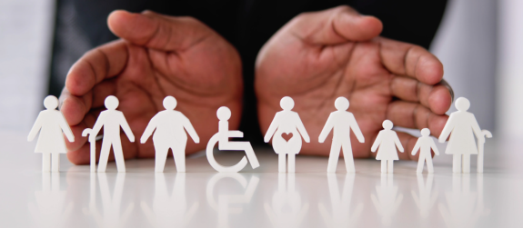 open hands behind small cutouts of silhouetted people with disabilities