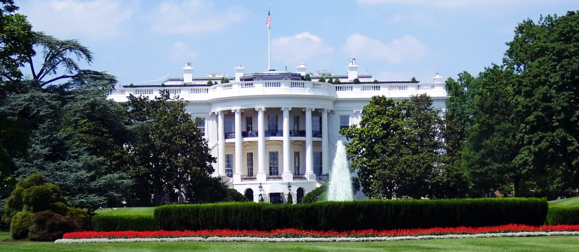 White Concrete Building With Flags on Top