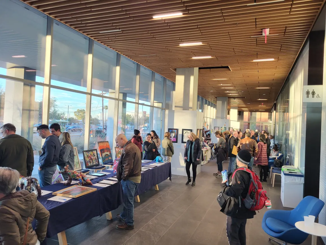 A crowd of attendees at the ArtWorks Face2Face exhibit