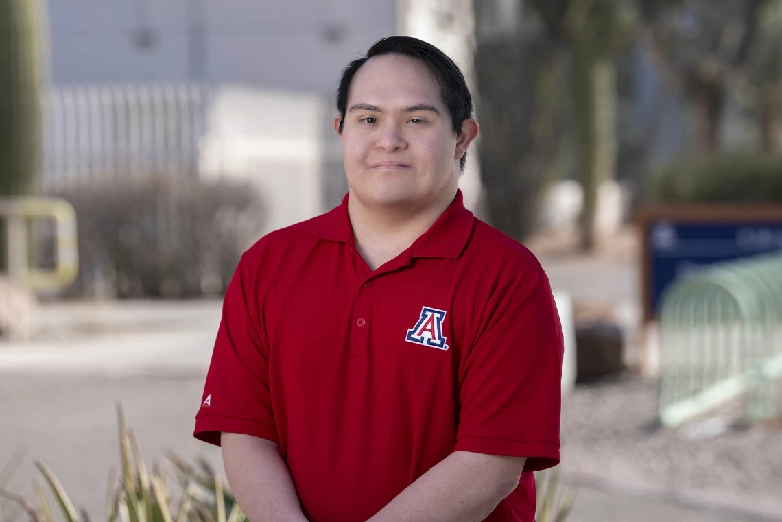 Hispanic man wearing a red polo