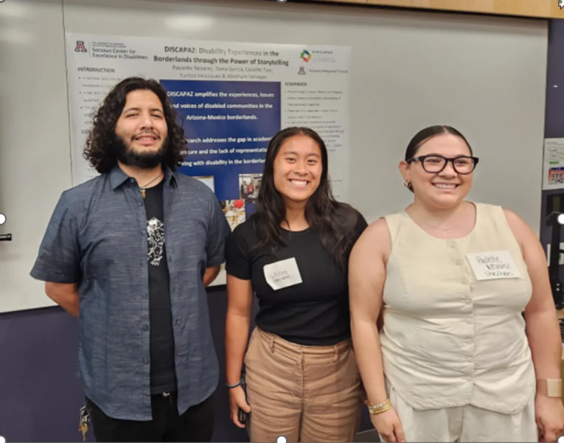 DISCAPAZ Team at Sonoran Center Trainee Symposium. Three team members, Abraham, Cosette and Paulette, pictured next to the DISCAPAZ poster. 