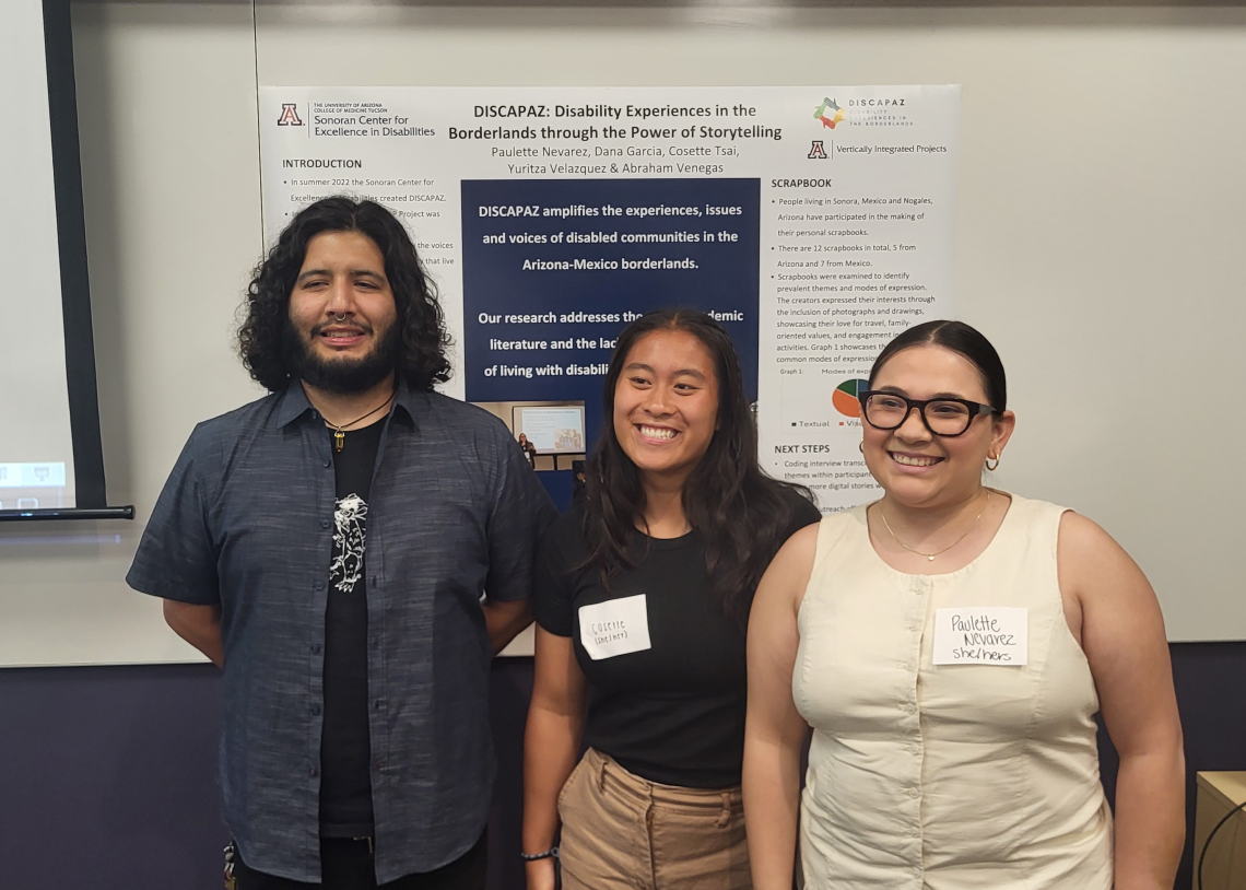 Paulette Nevarez, Cosette Tsai, and Abraham Venegas stand proudly in front of their poster detailing their work on the DISCAPAZ project