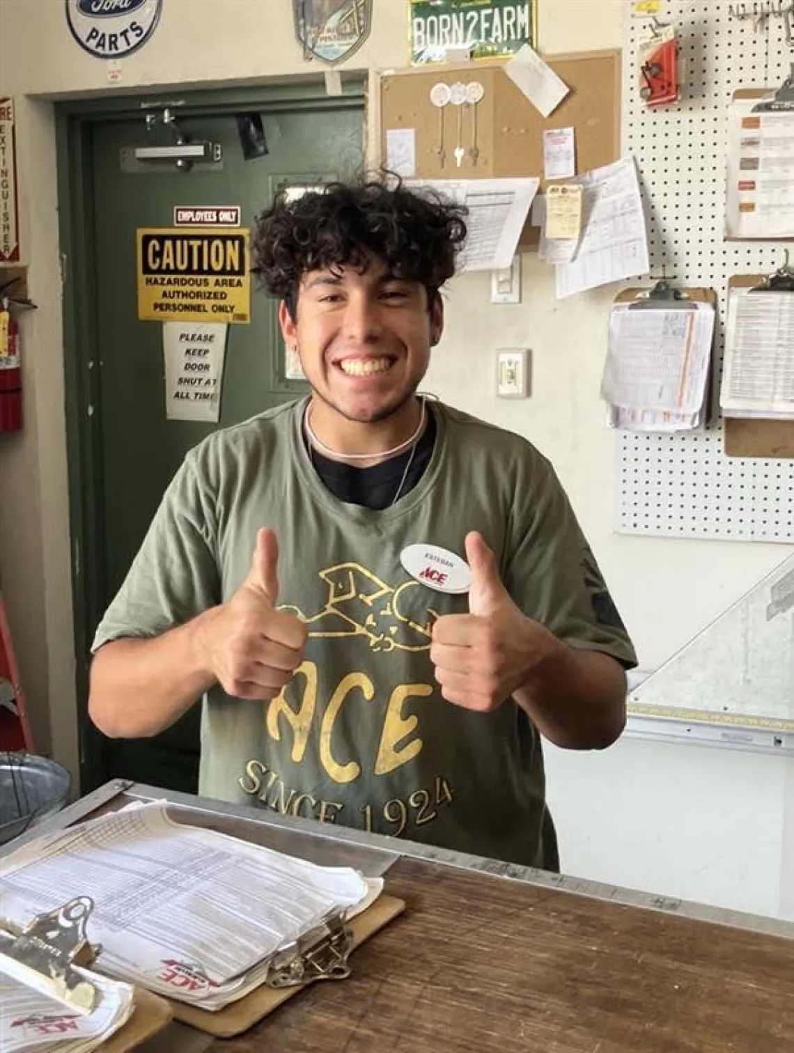 Student worker Esteban gives two-thumbs-up after being offered a job at ACE Hardware. 