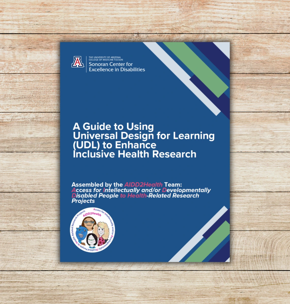 Image of blue guidebook cover on top of a wooden backgorund. The guidebook's title reads: A Guide to Using Universal Design for Learning (UDL) to Enhance Inclusive Health Research.