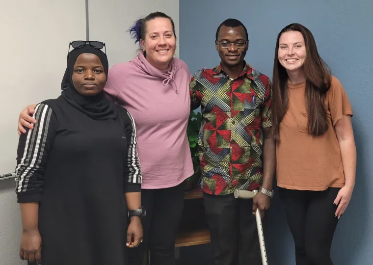 Pictured from left to right: Jalia Namiiro, Harunah's interpretter; Lindsay Janes from the Community Outreach Program for the Deaf;  Harunah; and Lyssa Matsche from the Community Outreach Program for the Deaf. The group met to discuss Harunah's project, and during the meeting exchanged ASL and Ugandan sign and enjoyed exploring the differences and similarities.