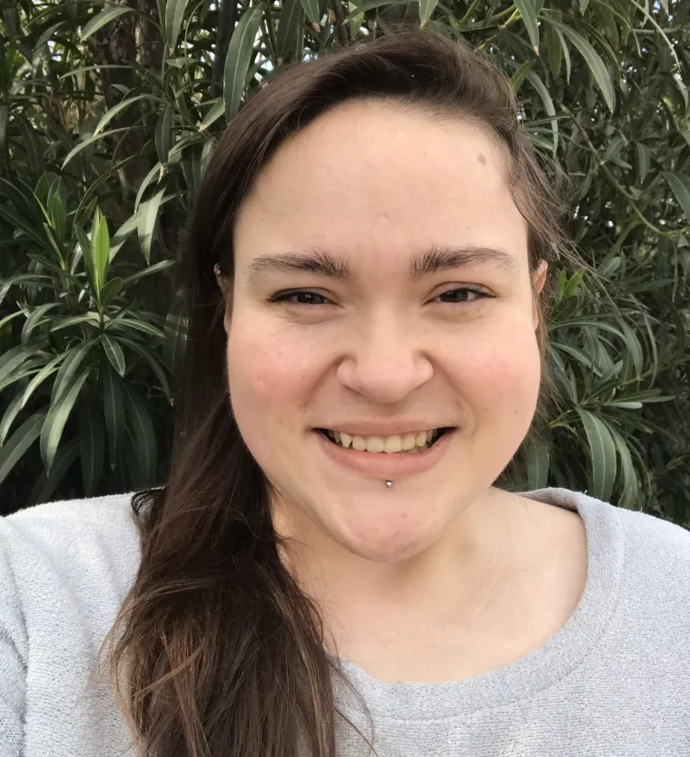 Jordan, smiling woman with long hair over her shoulder