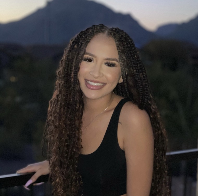 Jocelyn, smiling woman with long dark curly braids