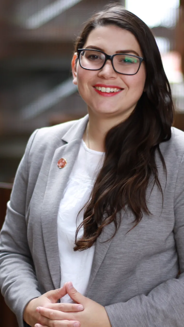 Roxanna, a girl with long dark hair and glasses smiling