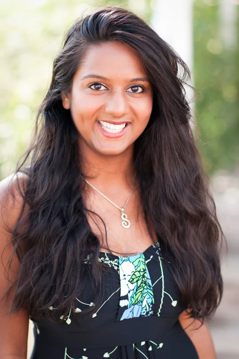 Shivani, a long dark wavy hair woman smiling