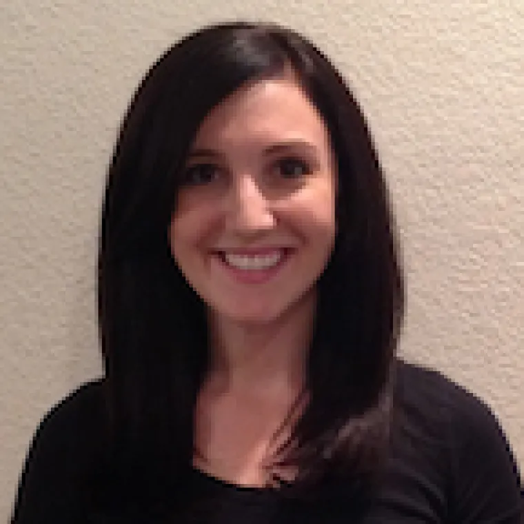 Woman with long dark hair smiling