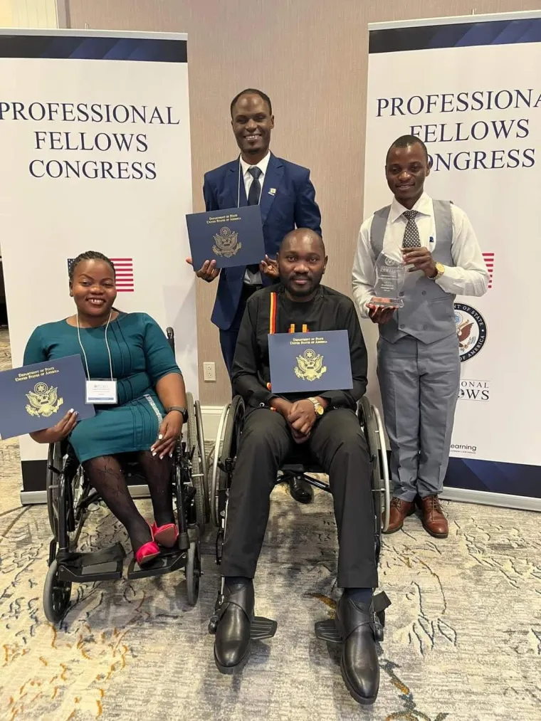 Denis Ouma and other Professional Fellows gathered in a group, showing their awards at the Professional Fellows Congress