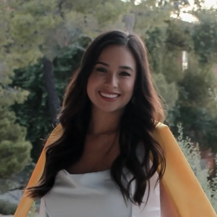 Headshot of Victoria Martinez, a young woman with long brown hair.