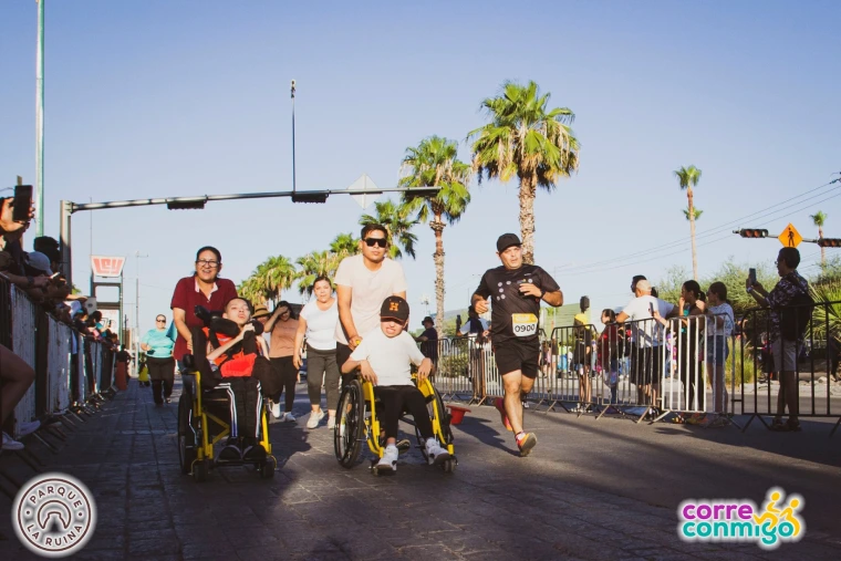 Racers and supporters cross the finish line in Corre Conmigo's eleventh annual race