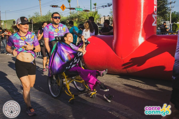 Racers and supporters cross the finish line in Corre Conmigo's eleventh annual race