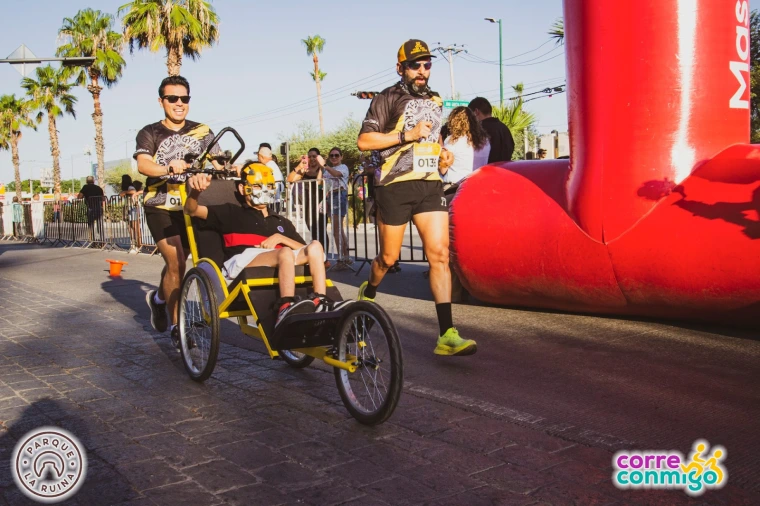 Racers and supporters cross the finish line in Corre Conmigo's eleventh annual race