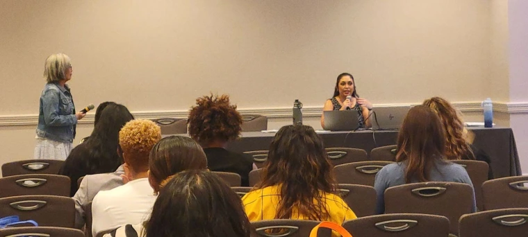 Lynne Tomasa and Celina Urquidez delivering their presentation, 'Designing a Trauma-Informed Curriculum: Focus on Safety, Empowerment, and Application'.
