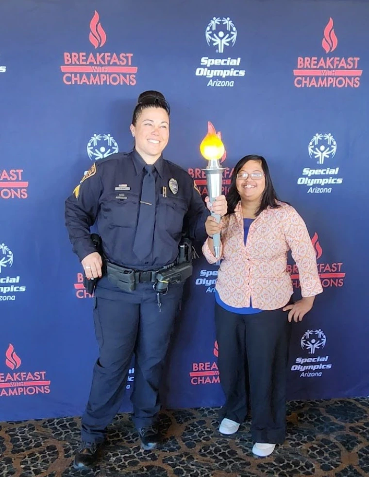 Pavleena Madhivanan and a TPD representative pose for a photo with the Torch