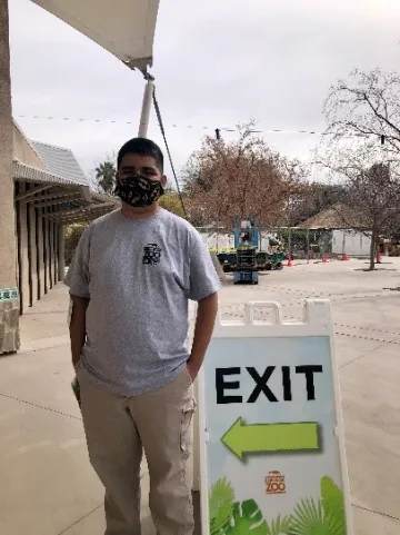 A disabled student worker in their first job as a Zoo Greeter at the Reid Park Zoo