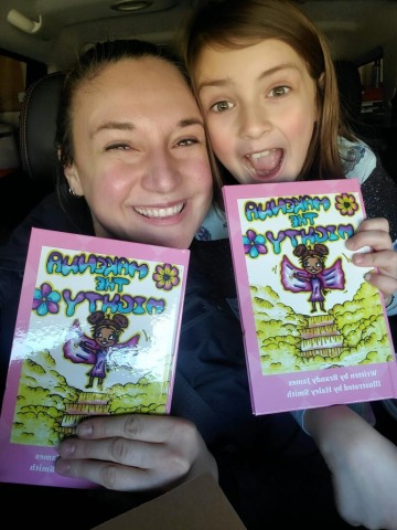 A mother and a daughter holding the 2 Makenna the Mighty books